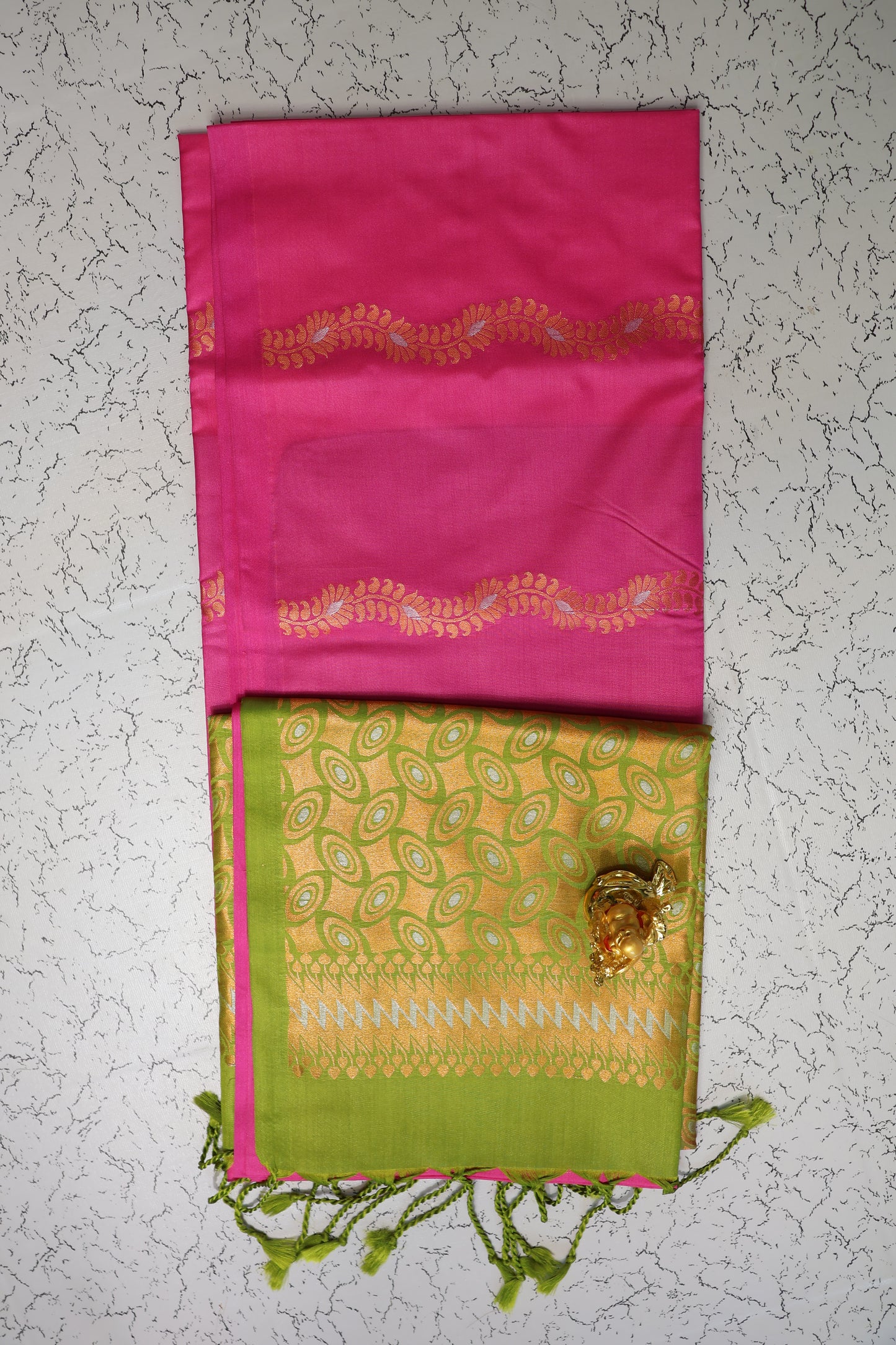 Traditional Rani pink saree with gold and silver zari pattern and green pallu