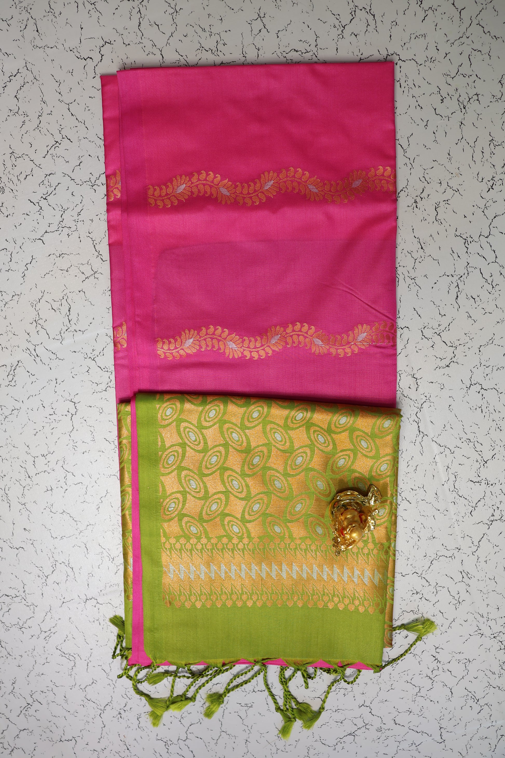 Traditional Rani pink saree with gold and silver zari pattern and green pallu